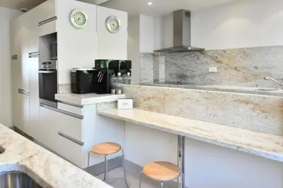 a kitchen with a counter and two stools at Résidence 3p Proche Centre Ville, Piscine Et Vue Mer - 3P proche centre ville, piscine et vue mer MAE-1673 in Cannes