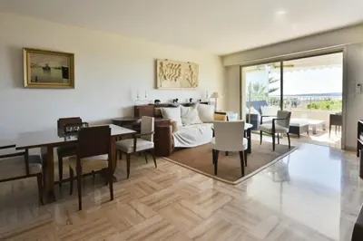 a living room with a dining table and a couch at Résidence 3p Proche Centre Ville, Piscine Et Vue Mer - 3P proche centre ville, piscine et vue mer MAE-1673 in Cannes