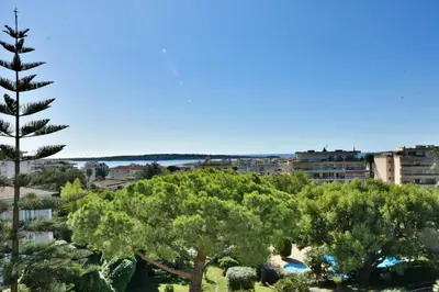 a view of a city with trees and buildings at Résidence 3p Proche Centre Ville, Piscine Et Vue Mer - 3P proche centre ville, piscine et vue mer MAE-1673 in Cannes