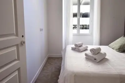 a bedroom with a bed with two towels on it at Résidence 4p Moderne En Centre-ville, 5min Palais & Plages ! - 4P moderne en centre-ville, 5min Palais & plages ! MAE-1683 in Cannes