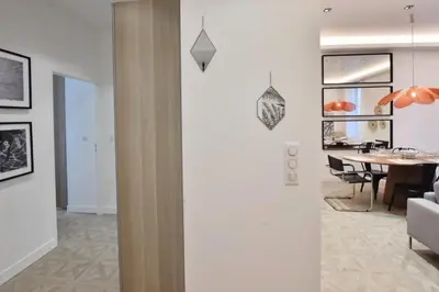 a living room and dining room with a dining table at Résidence 4p Moderne En Centre-ville, 5min Palais & Plages ! - 4P moderne en centre-ville, 5min Palais & plages ! MAE-1683 in Cannes