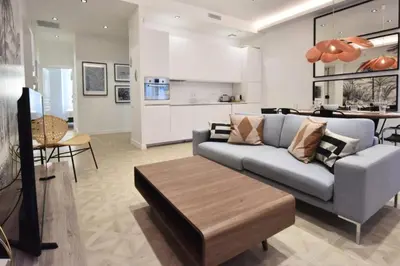 a living room with a couch and a table at Résidence 4p Moderne En Centre-ville, 5min Palais & Plages ! - 4P moderne en centre-ville, 5min Palais & plages ! MAE-1683 in Cannes