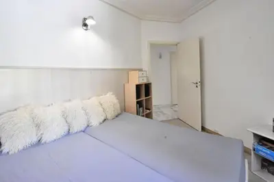 a white room with a bed with white pillows at Résidence 4p Avec Grande Terrasse Et Piscine - 4P avec grande terrasse et piscine MAE-1693 in Cannes