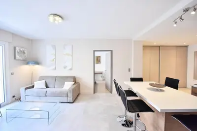 a living room with a table and a couch at Résidence 3p En Plein Cœur De Cannes, à 2min De La Croisette - 3P en plein cœur de Cannes, à 2min de la Croisette MAE-1703 in Cannes