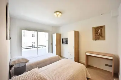 a bedroom with two beds and a fireplace at Résidence 3p En Plein Cœur De Cannes, à 2min De La Croisette - 3P en plein cœur de Cannes, à 2min de la Croisette MAE-1703 in Cannes