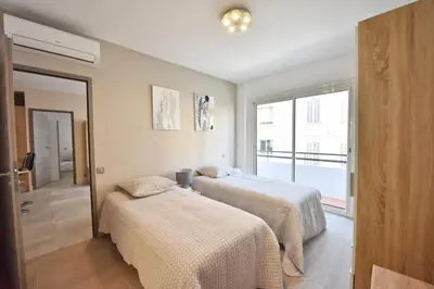 a bedroom with two beds and a window at Résidence 3p En Plein Cœur De Cannes, à 2min De La Croisette - 3P en plein cœur de Cannes, à 2min de la Croisette MAE-1703 in Cannes