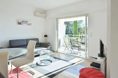 a living room with a glass table and a couch at Résidence 2p Avec Terrasse, Vue Mer, Piscine Et Parking - 2P avec terrasse, vue mer, piscine et parking MAE-1723 in Cannes