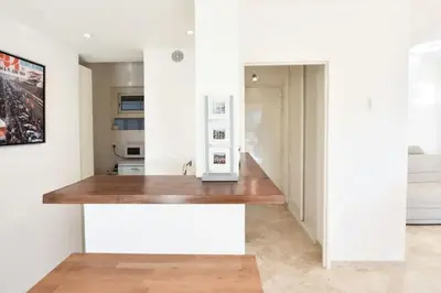 a kitchen with white walls and a wooden counter top at Résidence 2p Avec Terrasse, Vue Mer, Piscine Et Parking - 2P avec terrasse, vue mer, piscine et parking MAE-1723 in Cannes