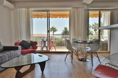 a living room with a couch and a table at Résidence 2p Avec Terrasse Et Vue Mer à Deux Pas Des Plages - 2P avec Terrasse et Vue Mer à deux pas des Plages MAE-1733 in Cannes