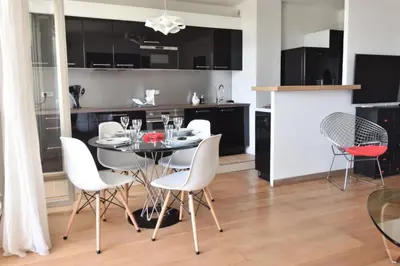 a kitchen and dining room with a table and chairs at Résidence 2p Avec Terrasse Et Vue Mer à Deux Pas Des Plages - 2P avec Terrasse et Vue Mer à deux pas des Plages MAE-1733 in Cannes