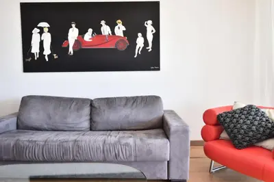 a living room with a couch and a picture of a car at Résidence 2p Avec Terrasse Et Vue Mer à Deux Pas Des Plages - 2P avec Terrasse et Vue Mer à deux pas des Plages MAE-1733 in Cannes