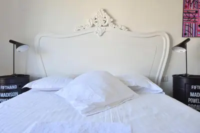 a white bed with a white headboard and pillows at Résidence 2p Avec Terrasse Et Vue Mer à Deux Pas Des Plages - 2P avec Terrasse et Vue Mer à deux pas des Plages MAE-1733 in Cannes
