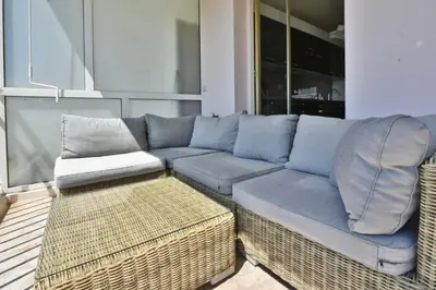 a blue couch and a chair in a living room at Résidence 2p Avec Terrasse Et Vue Mer à Deux Pas Des Plages - 2P avec Terrasse et Vue Mer à deux pas des Plages MAE-1733 in Cannes