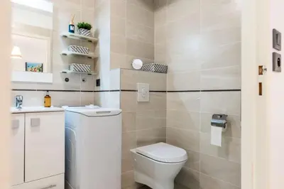 a small bathroom with a toilet and a sink at Résidence Rez-de-jardin Palm Beach, Piscine, Plages à Pied - Rez-de-jardin Palm Beach, piscine, plages à pied MAE-1753 in Cannes