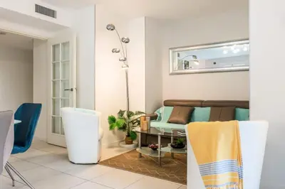 a living room with a couch and a table at Résidence Rez-de-jardin Palm Beach, Piscine, Plages à Pied - Rez-de-jardin Palm Beach, piscine, plages à pied MAE-1753 in Cannes