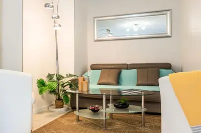 a living room with a couch and a table at Résidence Rez-de-jardin Palm Beach, Piscine, Plages à Pied - Rez-de-jardin Palm Beach, piscine, plages à pied MAE-1753 in Cannes