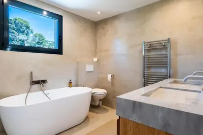 a bathroom with a large white tub and a toilet at Résidence Maison 10 Pers., Piscine, Proche Centre De Cannes - Maison 10 pers., piscine, proche centre de Cannes MAE-1773 in Cannes