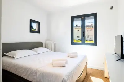 a bedroom with a white bed and a television at Résidence Maison 10 Pers., Piscine, Proche Centre De Cannes - Maison 10 pers., piscine, proche centre de Cannes MAE-1773 in Cannes
