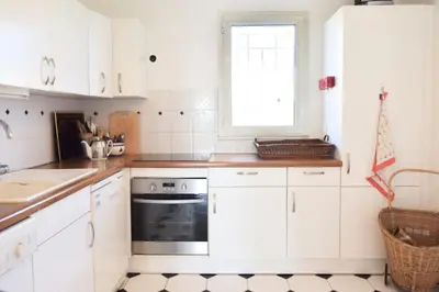 a kitchen with white cabinets and a black oven at Résidence 3 Pièces En Résidence Avec Piscine Et Vue Mer - 3 Pièces en Résidence avec Piscine et Vue Mer MAE-1793 in Cannes