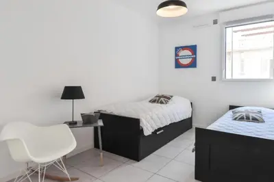 a bedroom with two beds and a desk and a chair at Résidence 3 Pièces Moderne Avec Piscine Au Palm Beach - 3 pièces moderne avec piscine au Palm Beach MAE-1803 in Cannes