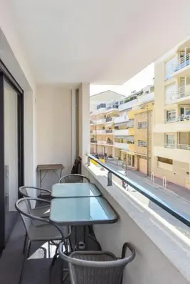 a balcony with tables and chairs and a window at Résidence 3 Pièces Moderne Avec Piscine Au Palm Beach - 3 pièces moderne avec piscine au Palm Beach MAE-1803 in Cannes