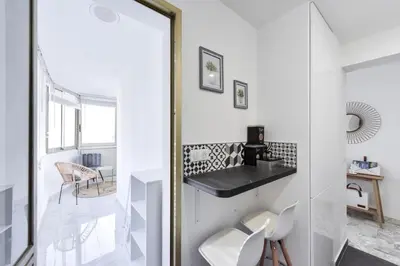 a white room with a mirror and a white chair at Résidence Cannes Palm Beach, 2 Min Des Plages - Cannes Palm beach, 2 min des plages MAE-1813 in Cannes