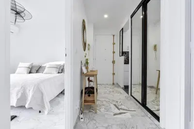 a white bedroom with a bed and a mirror at Résidence Cannes Palm Beach, 2 Min Des Plages - Cannes Palm beach, 2 min des plages MAE-1813 in Cannes