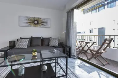 a living room with a couch and a table at Résidence Cannes Palm Beach, 2 Min Des Plages - Cannes Palm beach, 2 min des plages MAE-1813 in Cannes