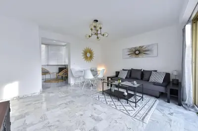 a living room with a couch and a table at Résidence Cannes Palm Beach, 2 Min Des Plages - Cannes Palm beach, 2 min des plages MAE-1813 in Cannes