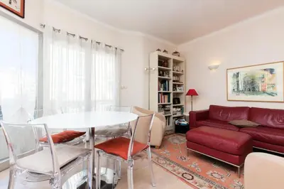 a living room with a red couch and a table at Résidence 3 Pièces En Centre-ville, Proche Croisette&palais - 3 pièces en centre-ville, proche Croisette&Palais MAE-1833 in Cannes