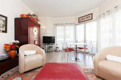 a living room with a table and chairs at Résidence 3 Pièces En Centre-ville, Proche Croisette&palais - 3 pièces en centre-ville, proche Croisette&Palais MAE-1833 in Cannes