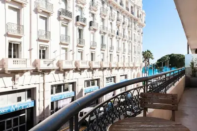 a bench on a balcony in front of a building at Résidence 3 Pièces En Centre-ville, Proche Croisette&palais - 3 pièces en centre-ville, proche Croisette&Palais MAE-1833 in Cannes