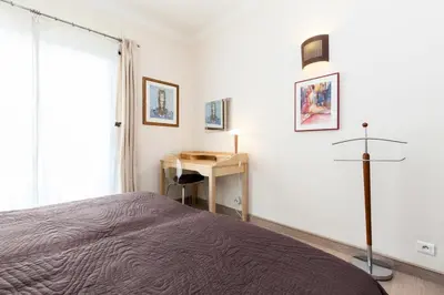 a bedroom with a bed and a desk and a window at Résidence 3 Pièces En Centre-ville, Proche Croisette&palais - 3 pièces en centre-ville, proche Croisette&Palais MAE-1833 in Cannes
