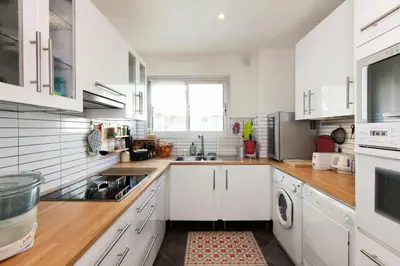 a kitchen with white cabinets and a sink at Résidence 3 Pièces En Centre-ville, Proche Croisette&palais - 3 pièces en centre-ville, proche Croisette&Palais MAE-1833 in Cannes