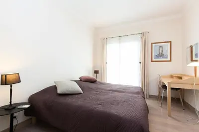 a bedroom with a bed and a desk and a window at Résidence 3 Pièces En Centre-ville, Proche Croisette&palais - 3 pièces en centre-ville, proche Croisette&Palais MAE-1833 in Cannes