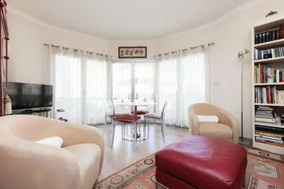 a living room with a table and chairs at Résidence 3 Pièces En Centre-ville, Proche Croisette&palais - 3 pièces en centre-ville, proche Croisette&Palais MAE-1833 in Cannes