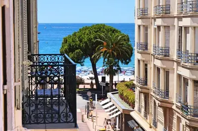 a view of the beach from a balcony of a building at Résidence 3p Moderne En Centre Ville, à 1min De La Croisette - 3P moderne en centre ville, à 1min de la Croisette MAE-1843 in Cannes