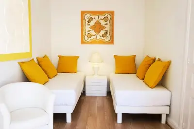 two beds in a room with yellow pillows at Résidence 3p Moderne En Centre Ville, à 1min De La Croisette - 3P moderne en centre ville, à 1min de la Croisette MAE-1843 in Cannes
