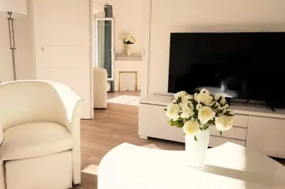 a living room with a vase of flowers on a table at Résidence 3p Moderne En Centre Ville, à 1min De La Croisette - 3P moderne en centre ville, à 1min de la Croisette MAE-1843 in Cannes