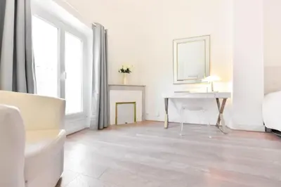 a white living room with a desk and a mirror at Résidence 3p Moderne En Centre Ville, à 1min De La Croisette - 3P moderne en centre ville, à 1min de la Croisette MAE-1843 in Cannes