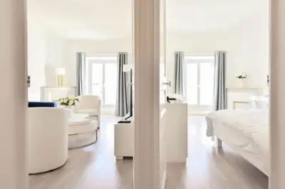 a white bedroom with a bed and a living room at Résidence 3p Moderne En Centre Ville, à 1min De La Croisette - 3P moderne en centre ville, à 1min de la Croisette MAE-1843 in Cannes