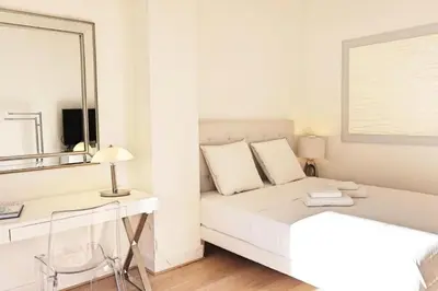 a white bedroom with a bed and a desk at Résidence 3p Moderne En Centre Ville, à 1min De La Croisette - 3P moderne en centre ville, à 1min de la Croisette MAE-1843 in Cannes