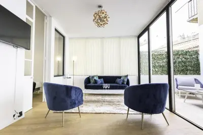 a living room with blue chairs and a couch at Résidence 3p Moderne Avec Terrasse En Plein Coeur De Cannes - 3P moderne avec terrasse en plein coeur de Cannes MAE-1863 in Cannes