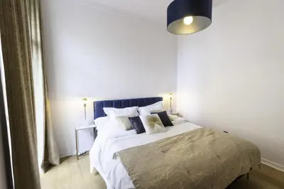 a bedroom with a large bed with a blue headboard at Résidence 3p Moderne Avec Terrasse En Plein Coeur De Cannes - 3P moderne avec terrasse en plein coeur de Cannes MAE-1863 in Cannes