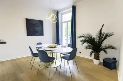 a dining room with a table and chairs and a plant at Résidence 3p Moderne Avec Terrasse En Plein Coeur De Cannes - 3P moderne avec terrasse en plein coeur de Cannes MAE-1863 in Cannes