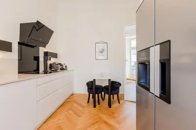 a kitchen with a table and two chairs and a refrigerator at Résidence Hyper Centre Cannes - 4p à 100m Du Palais - Hyper centre Cannes - 4P à 100m du palais MAE-1873 in Cannes