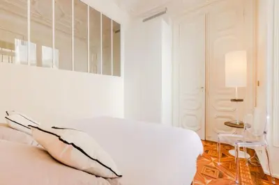 a white bedroom with a white bed and a table at Résidence Hyper Centre Cannes - 4p à 100m Du Palais - Hyper centre Cannes - 4P à 100m du palais MAE-1873 in Cannes