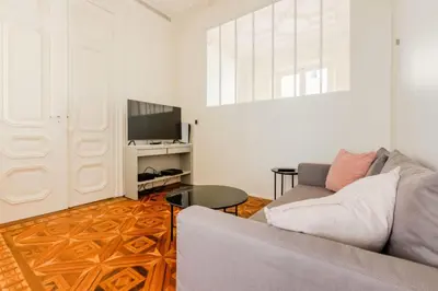a living room with a couch and a television at Résidence Hyper Centre Cannes - 4p à 100m Du Palais - Hyper centre Cannes - 4P à 100m du palais MAE-1873 in Cannes