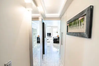 a hallway leading to a living room with a painting on the wall at Résidence 3p Pointe Croisette, Au Calme, Plages à Pied - 3P pointe Croisette, au calme, plages à pied MAE-1883 in Cannes