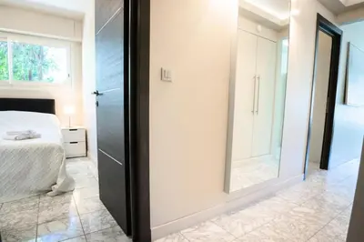 a bedroom with a bed and a mirror at Résidence 3p Pointe Croisette, Au Calme, Plages à Pied - 3P pointe Croisette, au calme, plages à pied MAE-1883 in Cannes